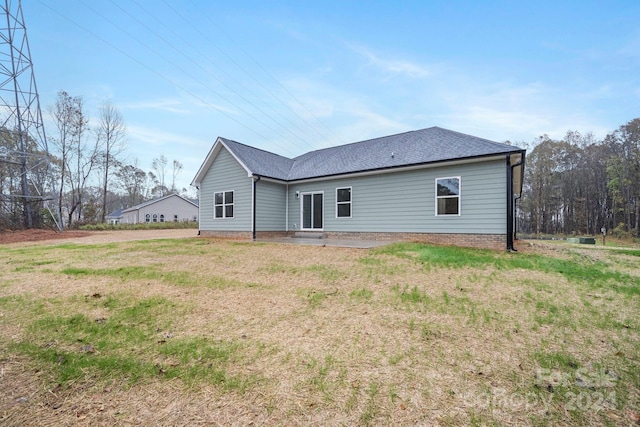 rear view of house with a yard