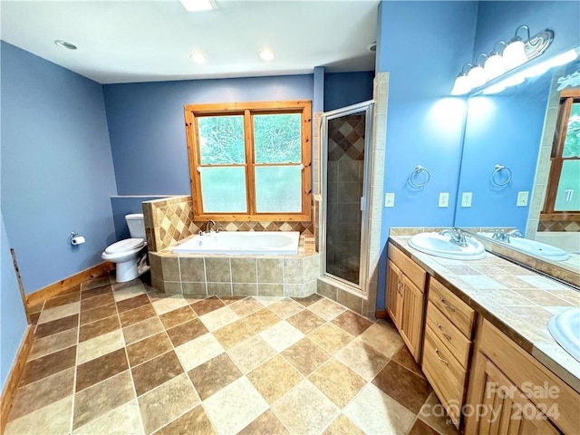 full bathroom featuring vanity, toilet, and independent shower and bath