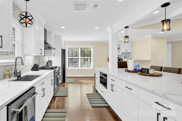 kitchen featuring decorative backsplash, sink, white cabinets, and appliances with stainless steel finishes