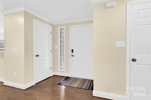 entryway with hardwood / wood-style floors and ornamental molding