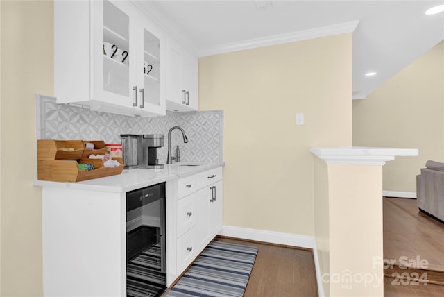 kitchen with decorative backsplash, white cabinetry, wine cooler, and dark wood-type flooring