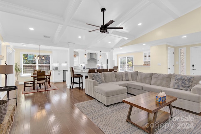 living room with light wood-type flooring, ornate columns, ornamental molding, ceiling fan, and lofted ceiling with beams