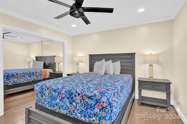 bedroom featuring hardwood / wood-style flooring, ceiling fan, and crown molding