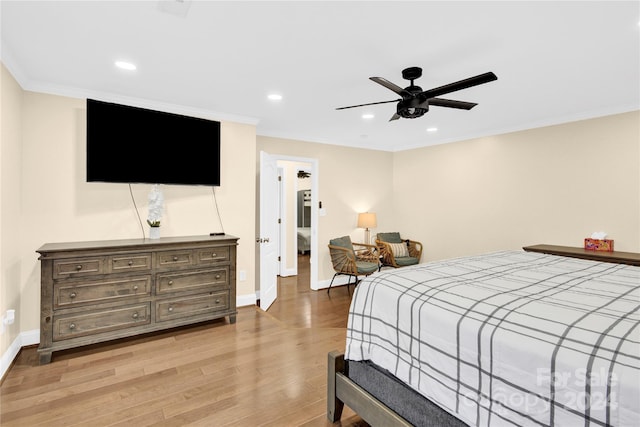 bedroom featuring ceiling fan, light hardwood / wood-style flooring, and ornamental molding