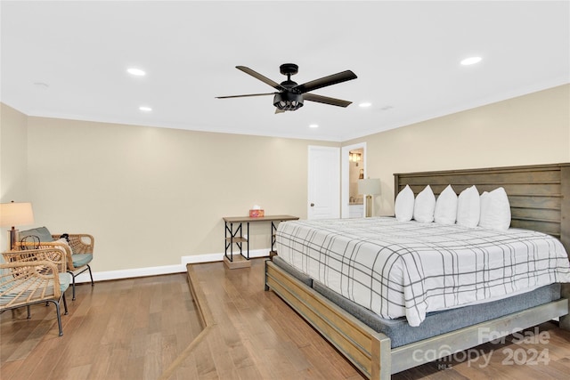 bedroom featuring light hardwood / wood-style flooring, ceiling fan, and ornamental molding