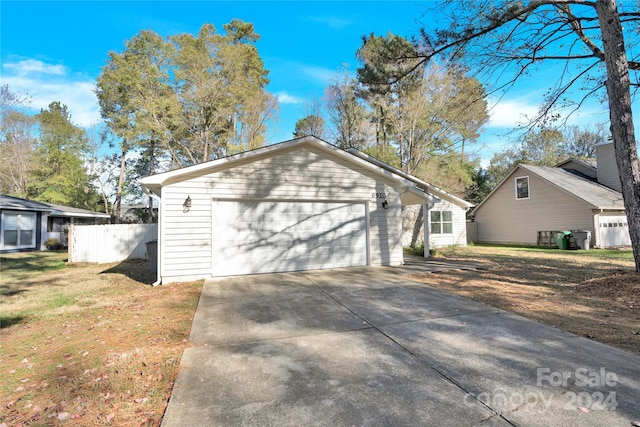 view of side of home with an outbuilding, a yard, and a garage