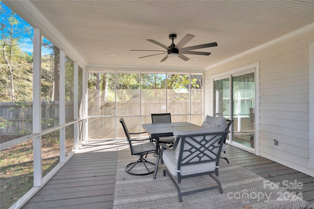 sunroom / solarium featuring ceiling fan