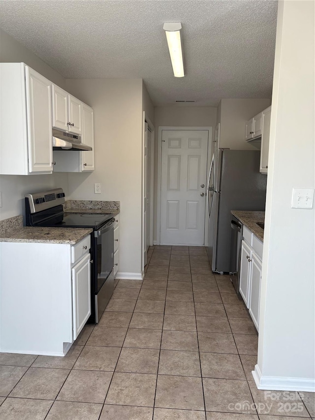 kitchen featuring white cabinets, appliances with stainless steel finishes, a textured ceiling, and light tile patterned floors