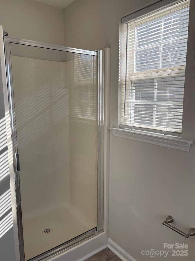 bathroom with a shower with door