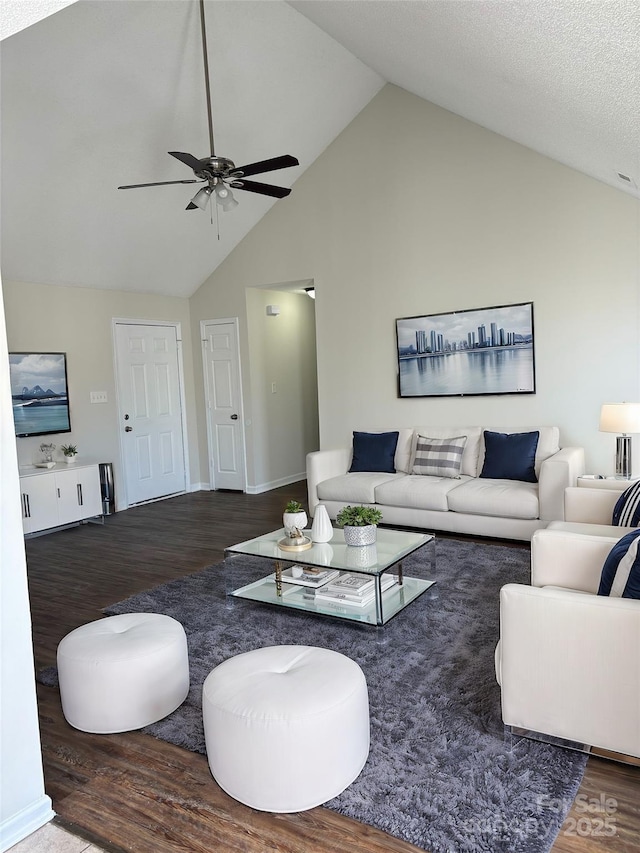 living room with dark hardwood / wood-style floors, high vaulted ceiling, and ceiling fan