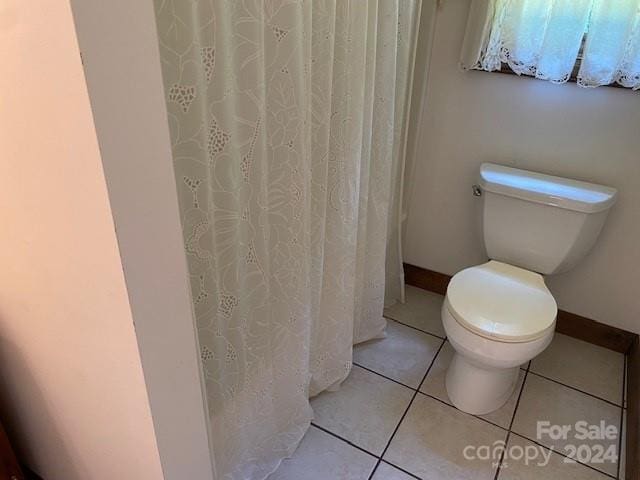 bathroom featuring toilet and tile patterned floors