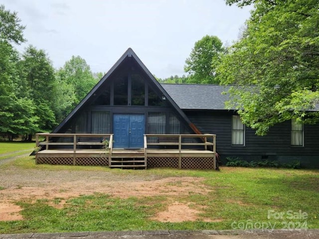 rear view of property featuring a lawn