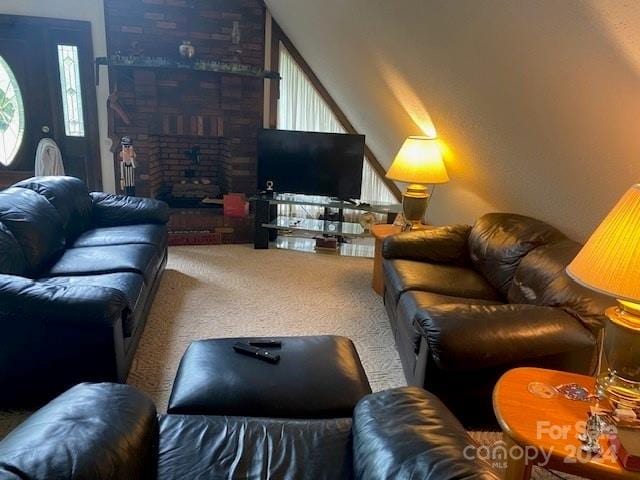 carpeted living room with a healthy amount of sunlight, lofted ceiling, and a brick fireplace