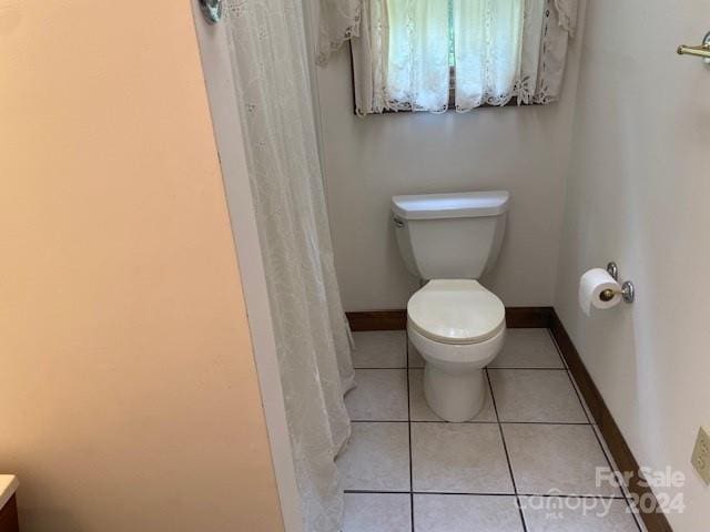 bathroom with tile patterned flooring and toilet