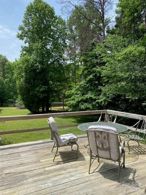 wooden terrace featuring a yard