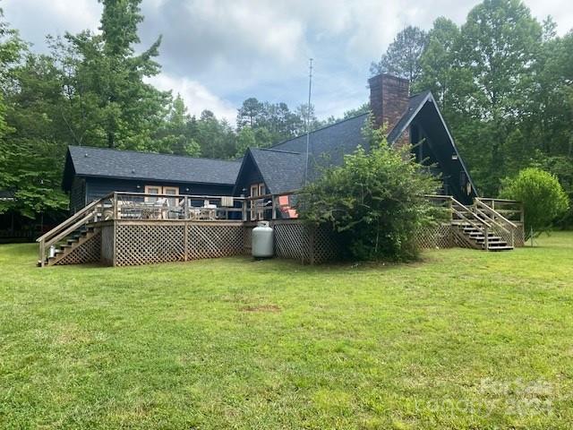 back of house featuring a yard and a deck