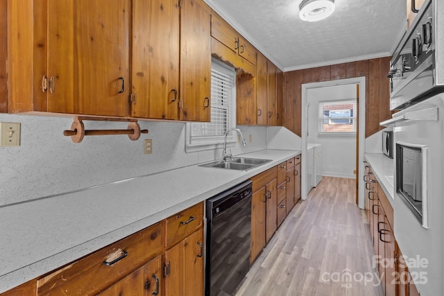 kitchen featuring a sink, black dishwasher, light countertops, ornamental molding, and brown cabinetry