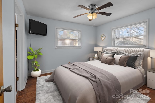 bedroom featuring a ceiling fan, baseboards, and wood finished floors