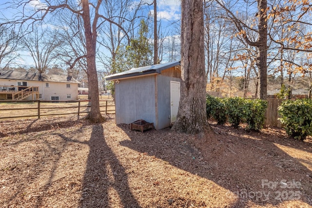 view of shed featuring fence