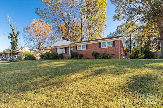 ranch-style house featuring a front lawn and covered porch