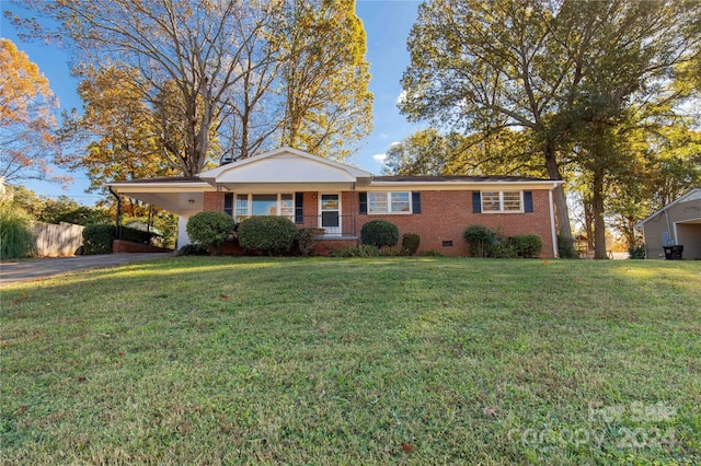 ranch-style home featuring a front yard and a carport