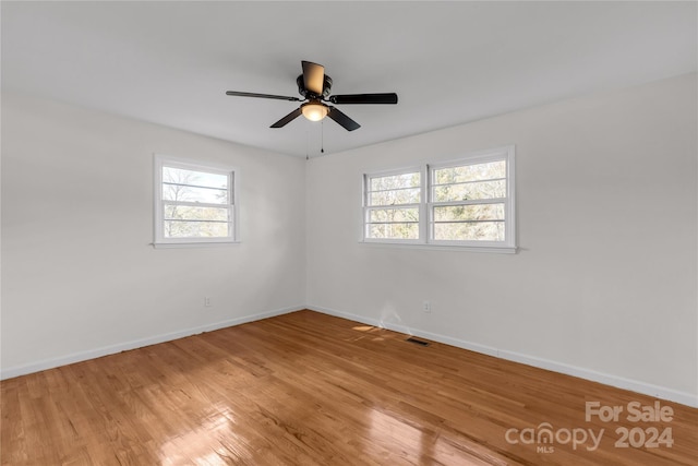 unfurnished room with hardwood / wood-style flooring and ceiling fan