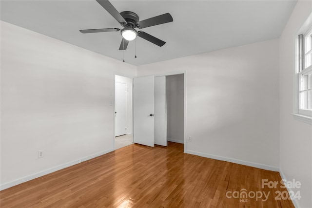 unfurnished bedroom with ceiling fan, a closet, and light hardwood / wood-style floors