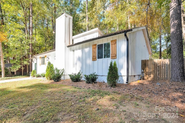 view of property exterior with a yard