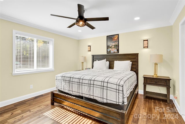 bedroom with wood-type flooring, ceiling fan, and ornamental molding