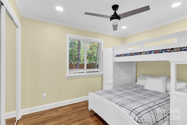 bedroom with a closet, ceiling fan, and hardwood / wood-style floors