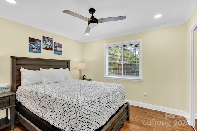 bedroom featuring wood-type flooring, ceiling fan, and crown molding