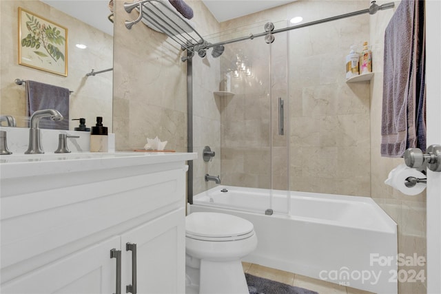 full bathroom featuring tile patterned floors, toilet, vanity, and combined bath / shower with glass door