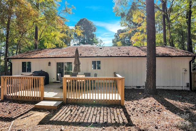 back of house featuring a wooden deck