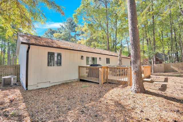 back of house featuring central AC and a deck