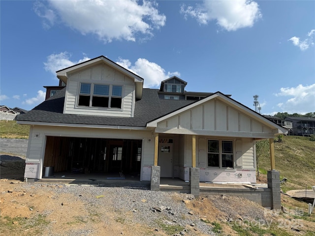 20 Craftsman Overlook Ridge, Arden, NC 28704 - view of front of house with board and batten siding, covered porch, a shingled roof, and gravel driveway