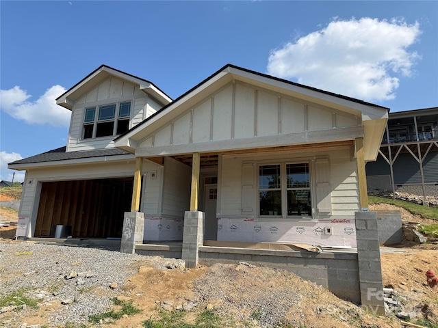 20 Craftsman Overlook Ridge, Arden, NC 28704 - unfinished property with board and batten siding, an attached garage, and covered porch
