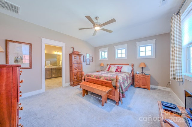 bedroom with ensuite bathroom, light colored carpet, ceiling fan, and lofted ceiling