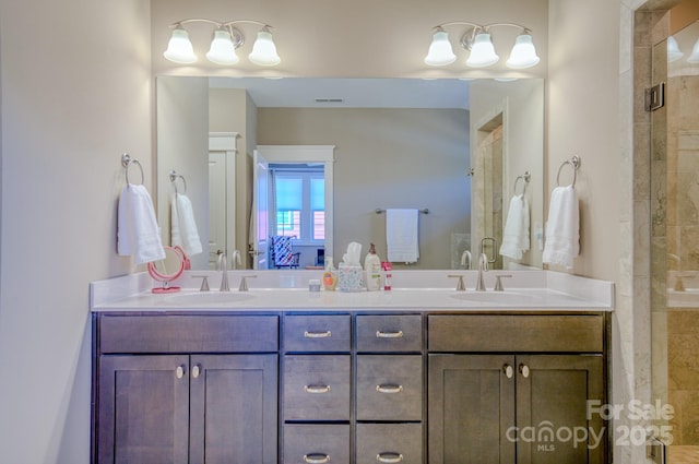 bathroom with vanity and an enclosed shower