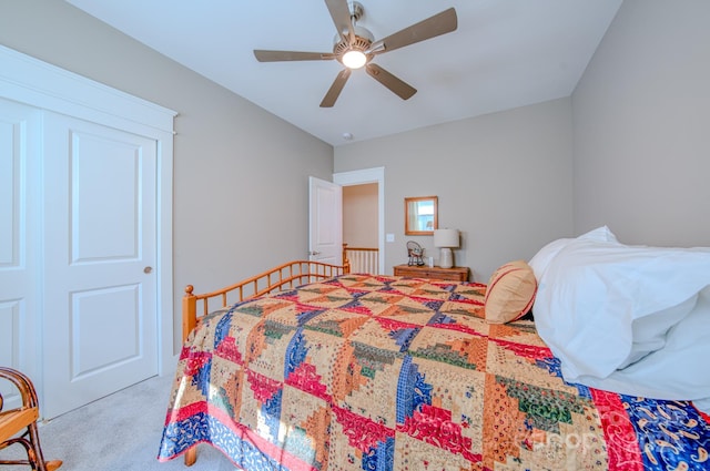 bedroom with ceiling fan, a closet, and light colored carpet