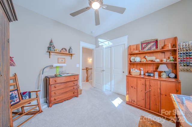 bedroom with ceiling fan, a closet, and light colored carpet