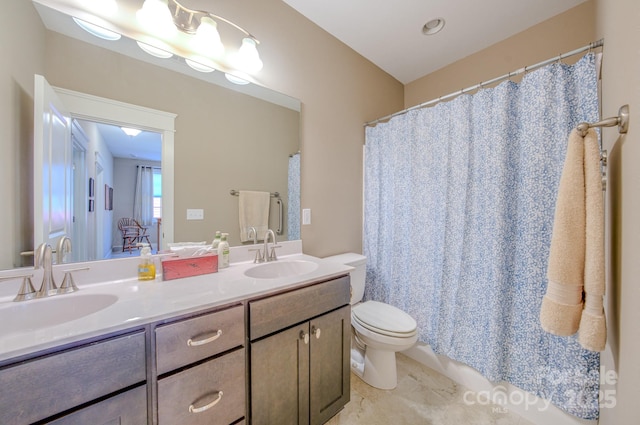 bathroom featuring toilet, vanity, and tile patterned flooring