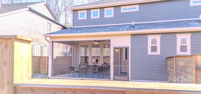 rear view of property featuring ceiling fan and a patio area