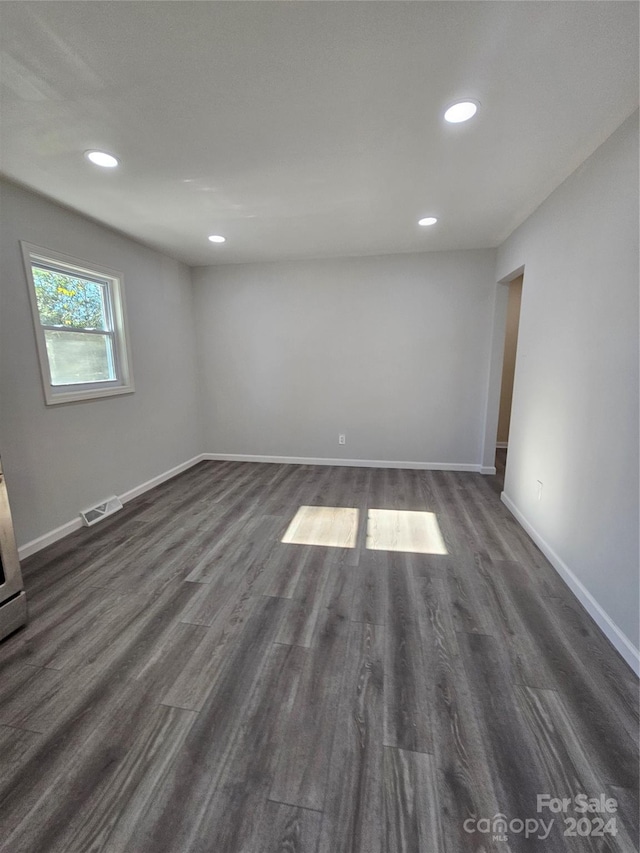 empty room featuring dark hardwood / wood-style flooring