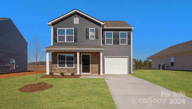 view of front facade with a garage and a front lawn