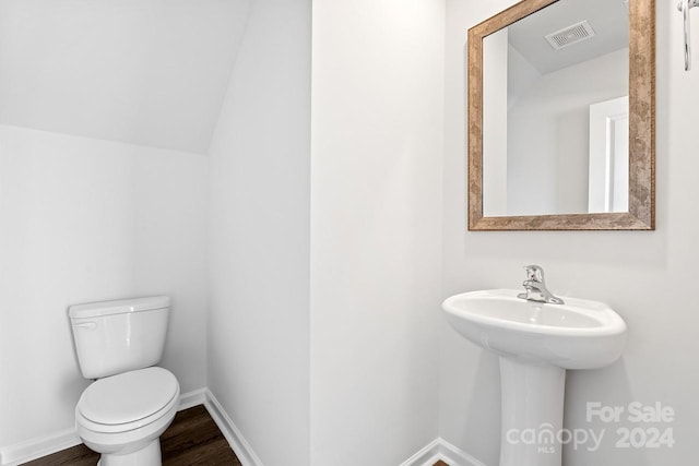 bathroom with hardwood / wood-style floors, toilet, and sink