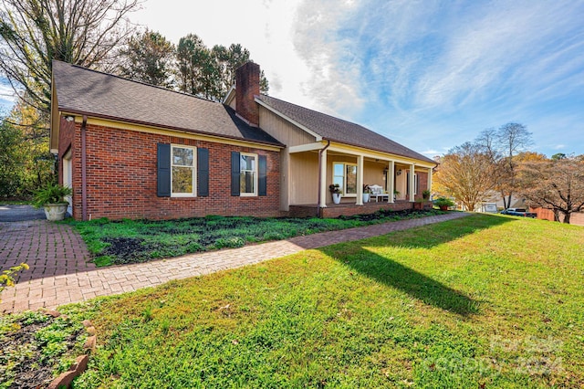 view of front of home featuring covered porch and a front yard