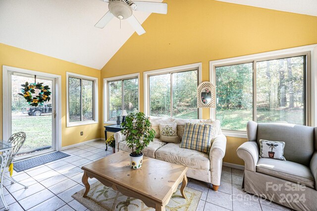 sunroom / solarium with ceiling fan, a wealth of natural light, and vaulted ceiling