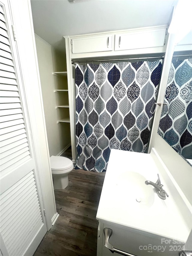 bathroom featuring hardwood / wood-style floors, vanity, and toilet