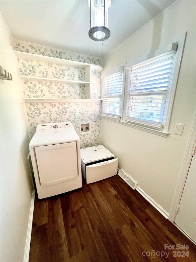 interior space featuring washer / dryer, ornamental molding, and dark wood-type flooring