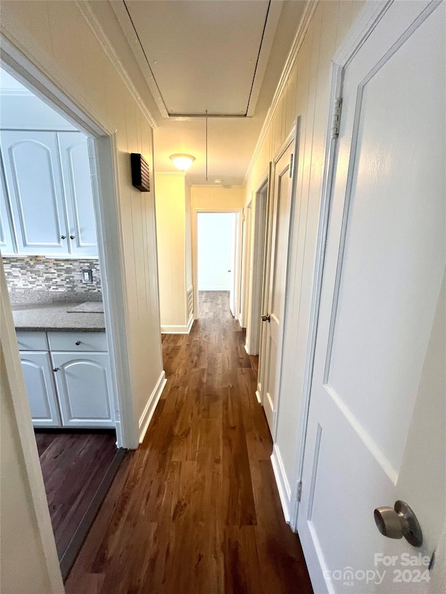 hallway featuring dark hardwood / wood-style flooring and ornamental molding